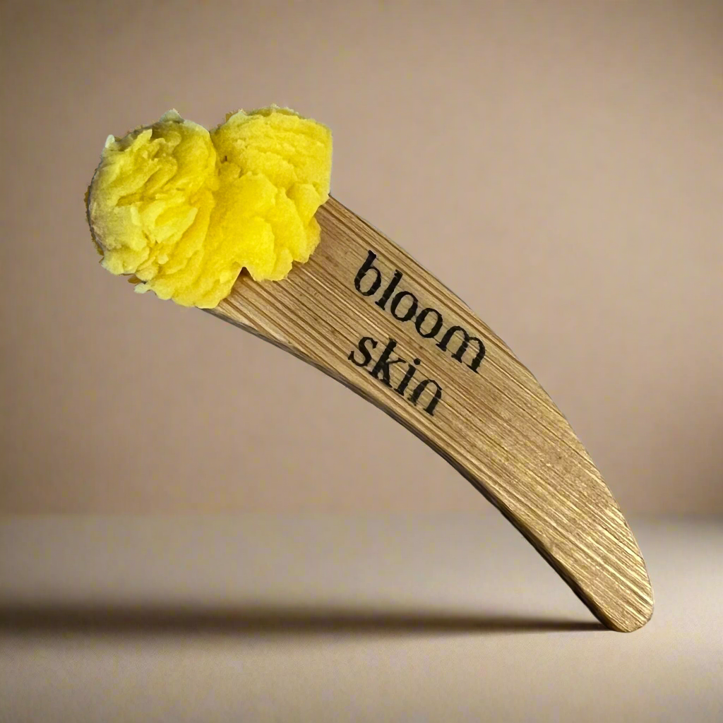 Wooden tool with yellow bristles on a wooden background