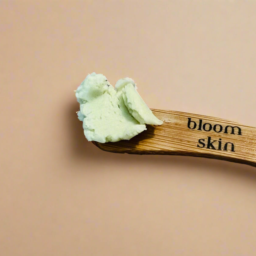 Bamboo stick with green substance on a wooden surface