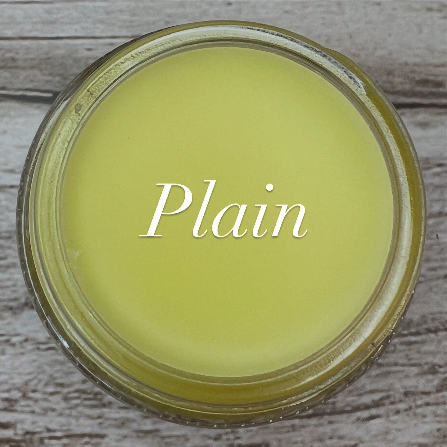 Jar lid with 'Plain' text on a wooden surface