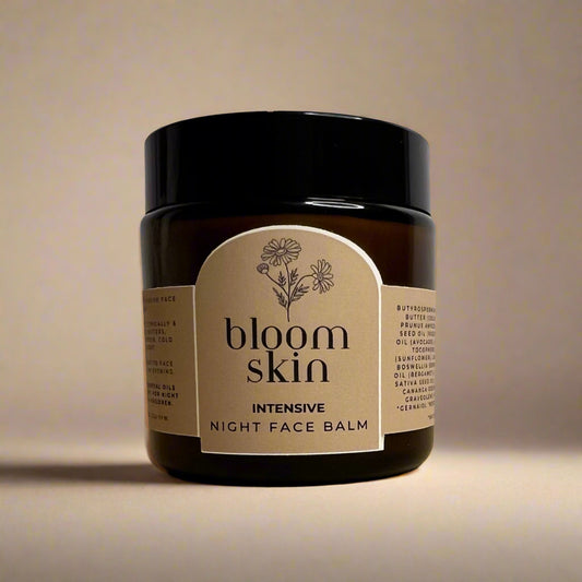 Jar of 'bloom skin' intensive night face balm on a beige surface with a light gray background
