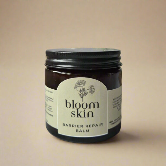 Jar of 'bloom skin' barrier repair balm on a neutral background