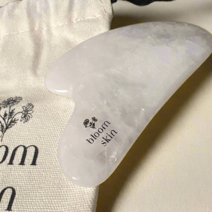 Bloom Skin facial towels and products on a wooden surface